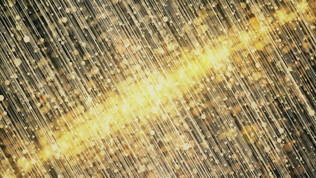 Sparkles of golden glitter moving vertically