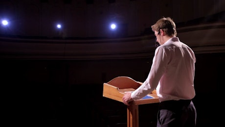 Speaker giving a speech at a forum.