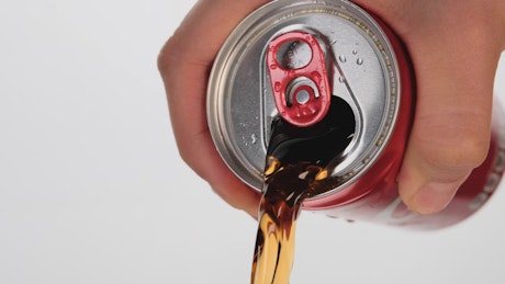 Spilling a can of cola.