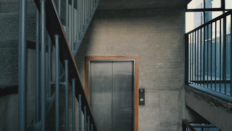 Stairwell with cement walls and an elevator