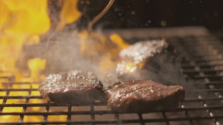 Steak on the grill in slow motion.