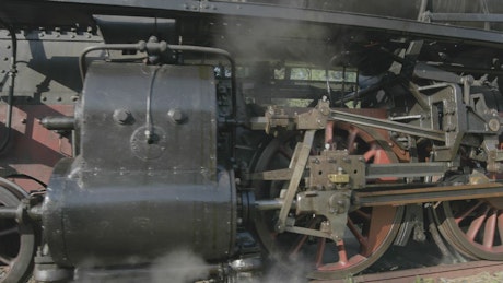 Steam train wheels in motion.