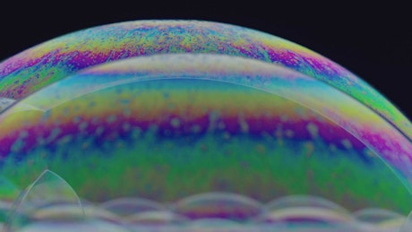 Strange shapes in soap bubbles with iridescent effect.