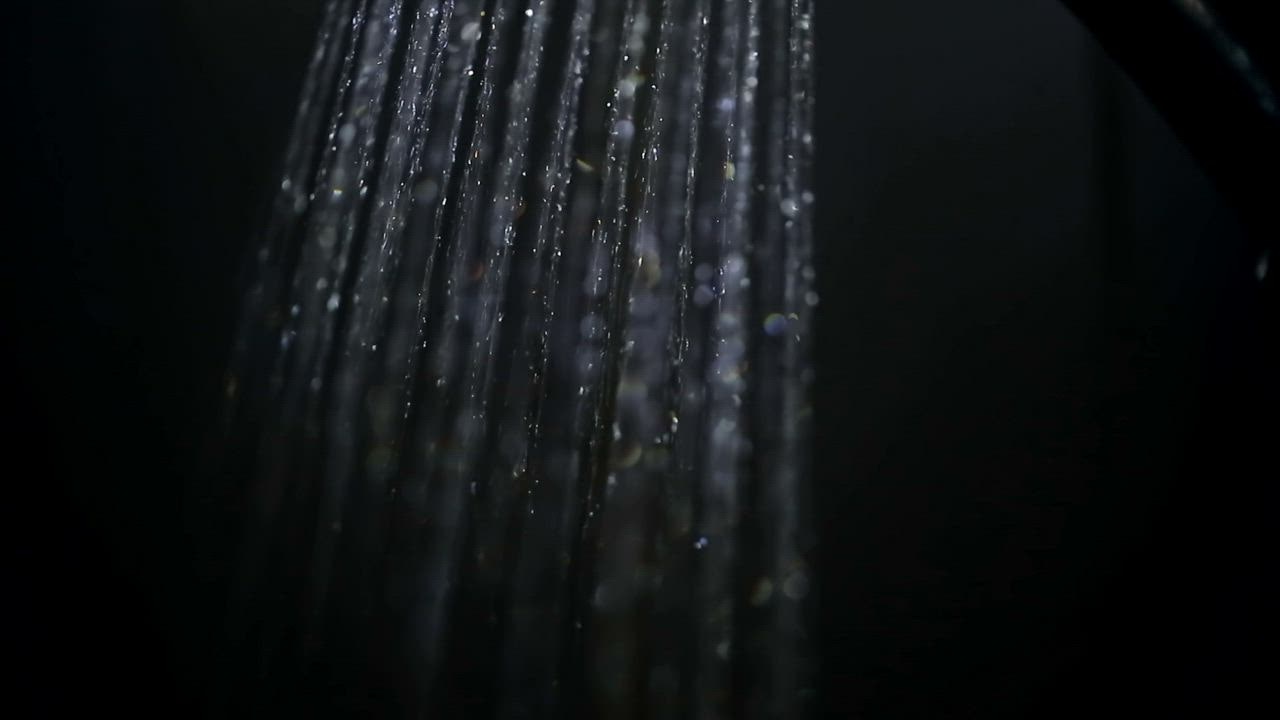 Stream of shower water on black background - Free Stock Video