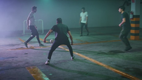 Street soccer game in a parking lot