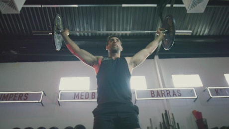 Strong man exercising with a barbell.