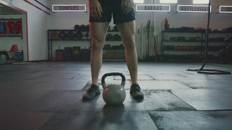 Strong man exercising with a kettlebell.
