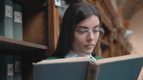 Student surprised by something she reads in book