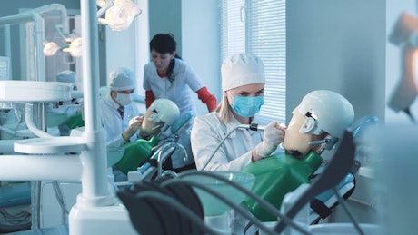 Students practicing a dental treatment.