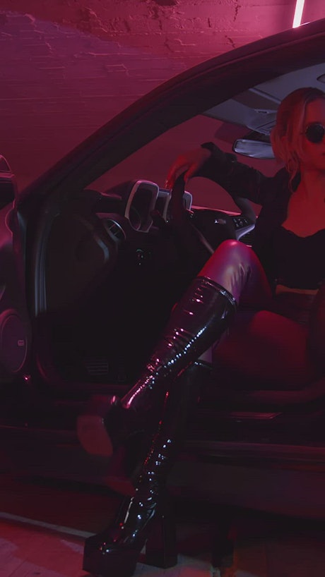 Stylish woman sitting in a sports car.