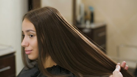 Stylist combing her client's hair