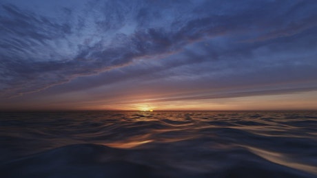 Sunset behind the waves of the sea