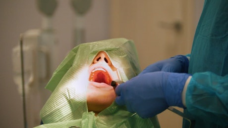 Surgeons working on a patients mouth