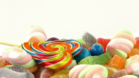 Sweet candies of different types on white background.