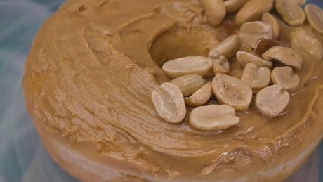 Taking a peanut butter donut from a plate.