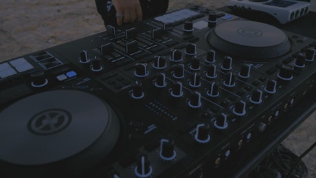 Talented DJ playing in a desert in a close-up shot.