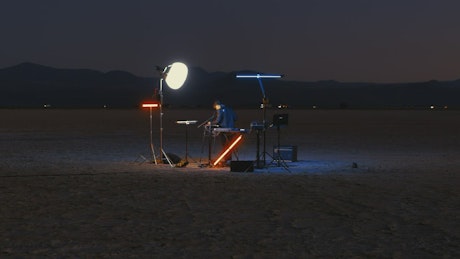 Talented DJ playing in a lonely desert.