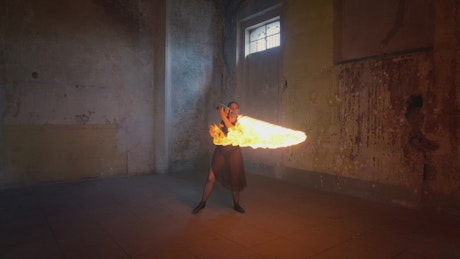 Talented woman doing a dance with a sword of fire.
