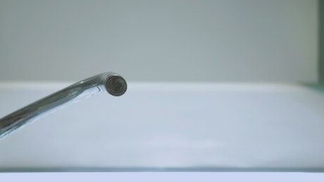 Tap turns on to pour water seen from below