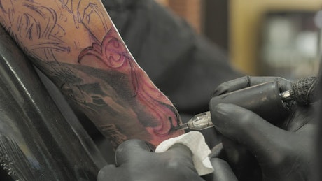 Tattoo being applied.