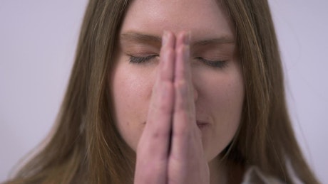 Tearful woman looks up and prays