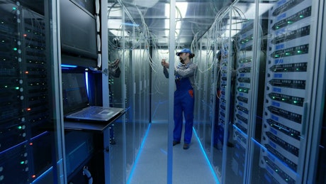 Technician working with cables in the data center.