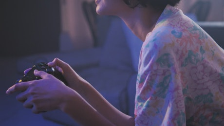 Teen playing video games in the living room