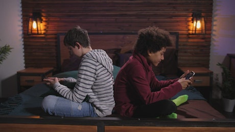 Teens playing mobile games
