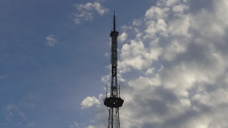 Telecommunication tower with sky in the background.
