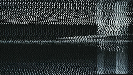 Television screen with static in black and white.