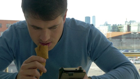 Texting while eating an ice cream