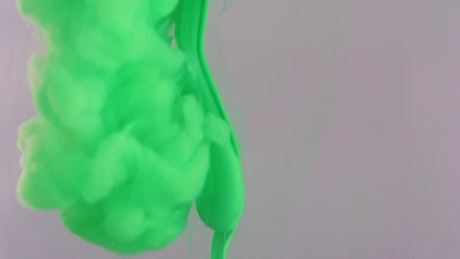 Texture of a cloud of green ink entering water.
