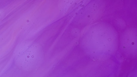 Texture of a thick purple liquid slowly flowing.