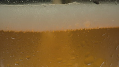 Texture of beer being served in a glass.