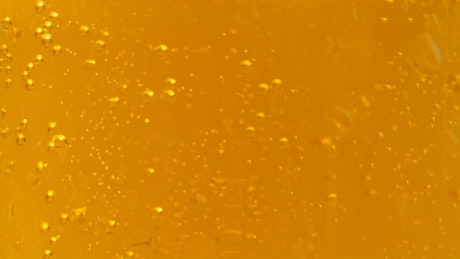 Texture of beer effervescent bubbles going upwards.