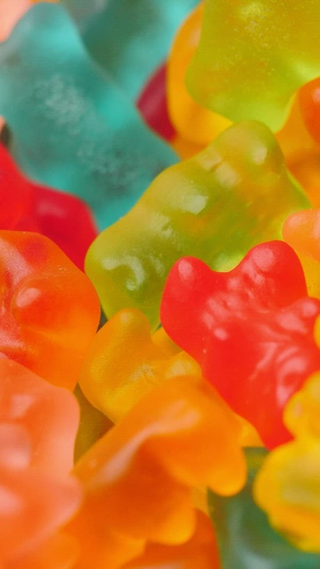 Texture of many colorful gummy pandas.