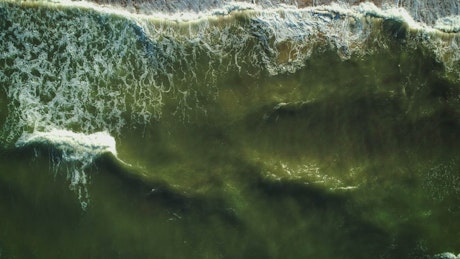 Texture of sea waves reaching the beach