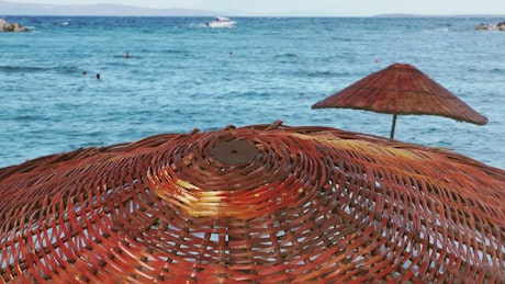 The sea seen from above a wooden umbrella