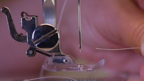 Threading a sewing machine needle
