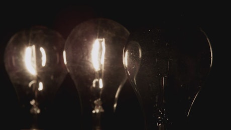 Three light bulbs illuminate.