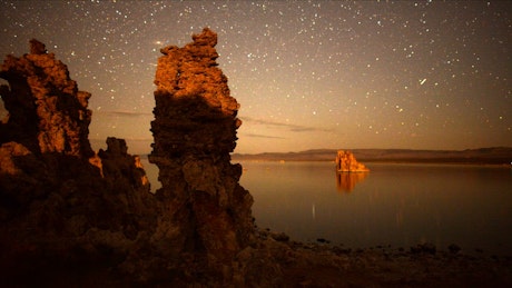 Time lapse of a starry night in a desert lake.