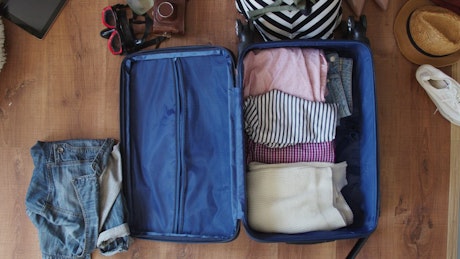 Time lapse of a suitcase being packed for a holiday.
