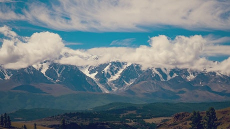 Time lapse of clouds rolling over a mountain range.