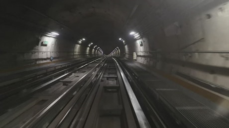 Timelapse of a train riding through a subway tunnel.