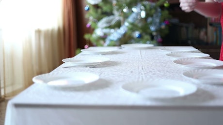 Timelapse of a woman setting the table for Christmas feast.