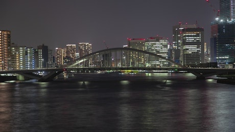 Tokyo bridge and water transport at night.
