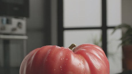 Tomato being prepared in a kitchen