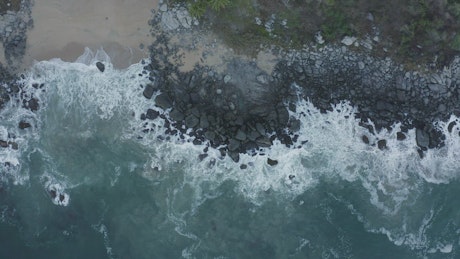 Top aerial shot of seashore with rocks.