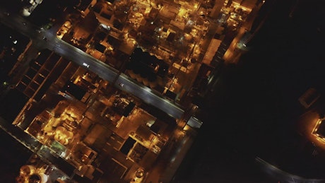 Top aerial view of a factory during night time.