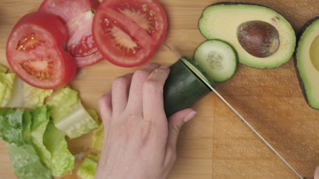 Top view of a woman slicing vegetables